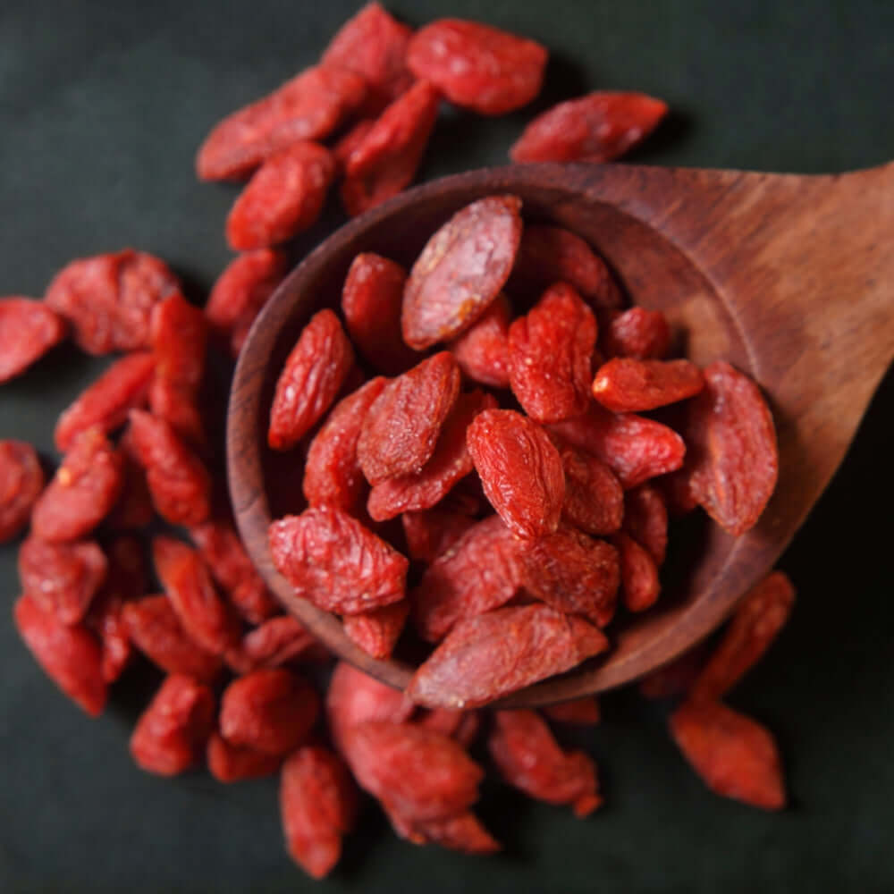 Dried Goji Berries in a wooden spoon